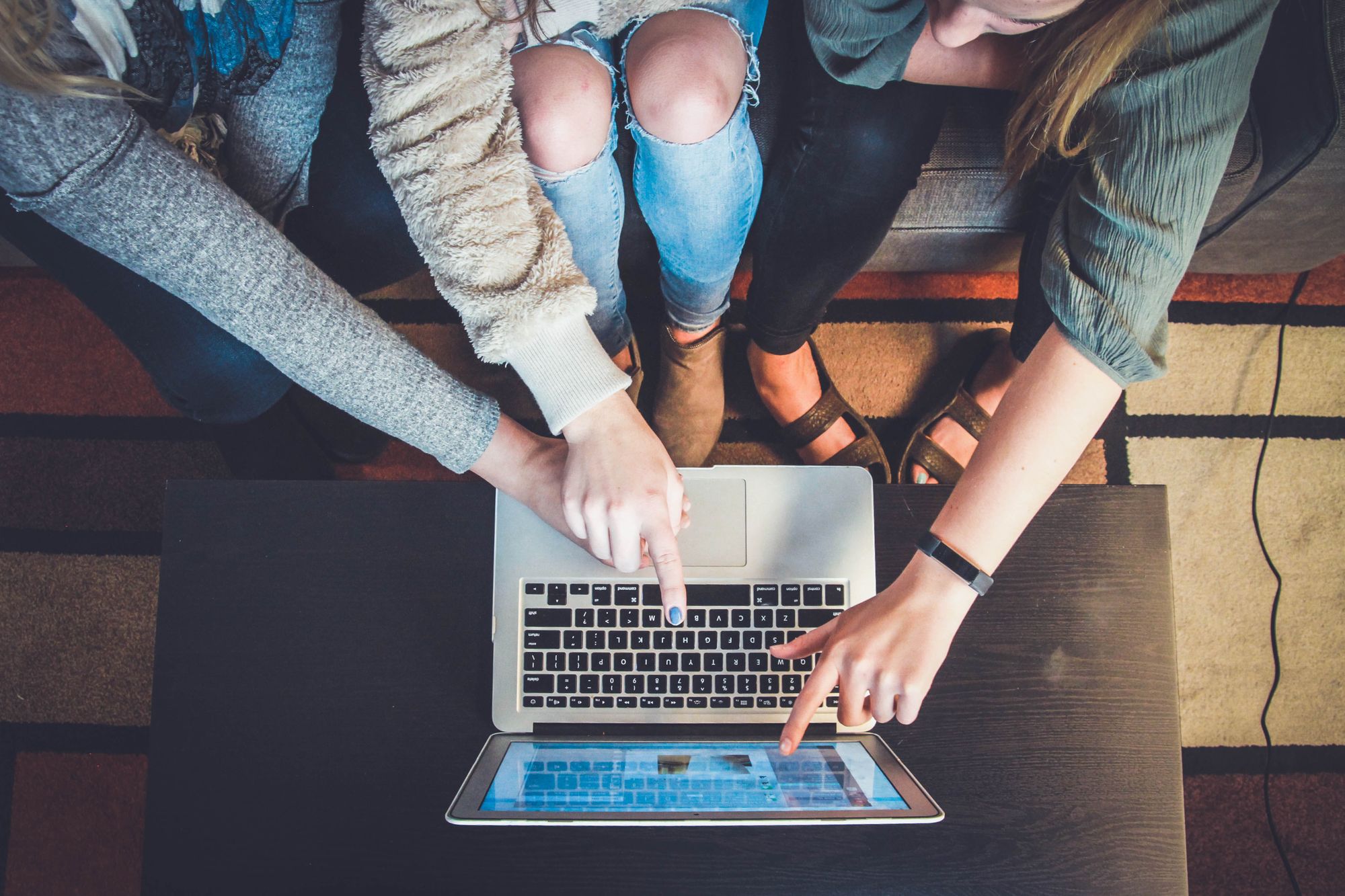 people around a laptop